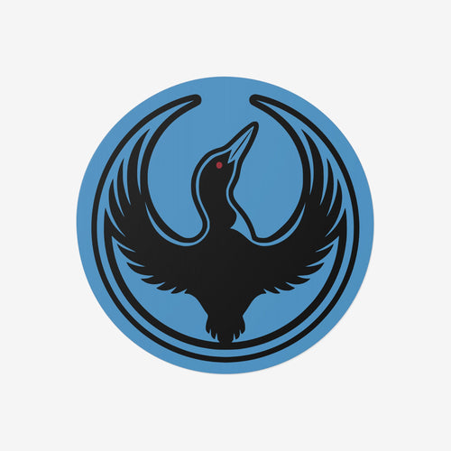 Minnesota Rebel Alliance Sticker featuring Bernie Anderson’s stylized loon logo, a black bird in flight on a blue circular emblem, symbolizing resistance and immigrant rights advocacy. Available in 3” or 5” vinyl sizes.