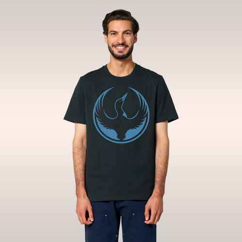 Young person wearing a black Minnesota Rebel Alliance T-shirt with a bold loon graphic, crouching in front of a cityscape. Th