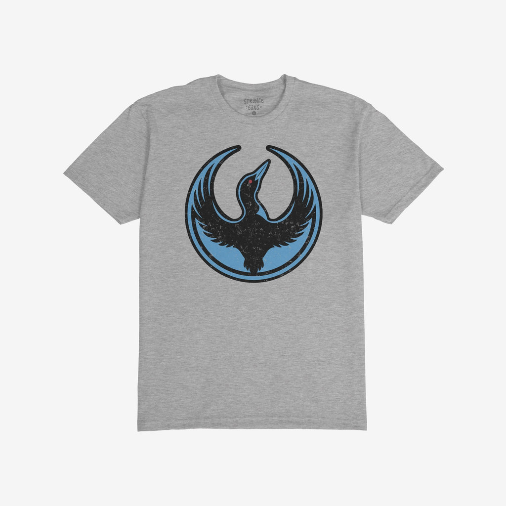 Heather-gray Minnesota Rebel Alliance T-shirt featuring a stylized loon emblem with wings raised and a red eye, symbolizing boldness and resistance. The shirt's design reflects a commitment to equality and social justice.