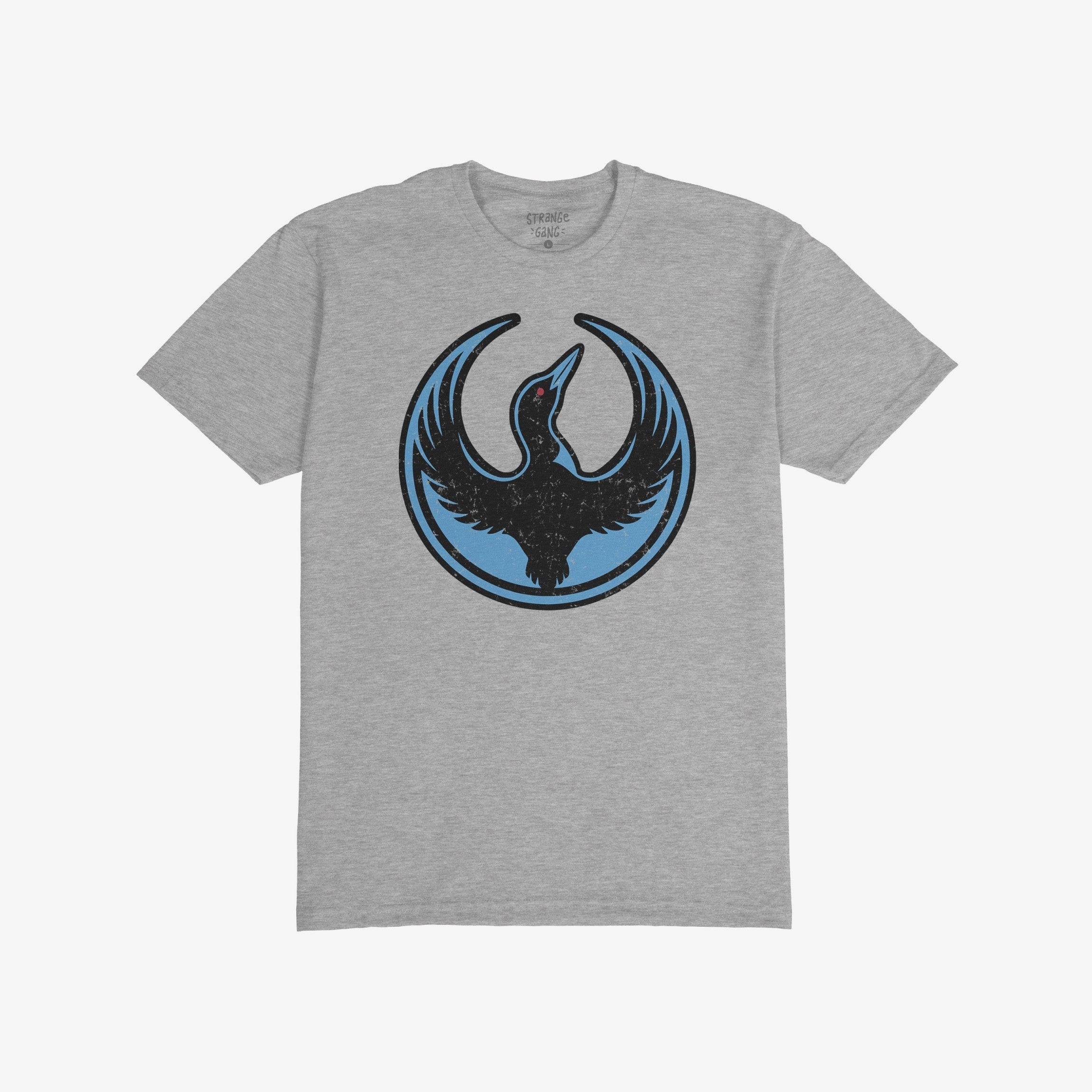 Heather-gray Minnesota Rebel Alliance T-shirt featuring a stylized loon emblem with wings raised and a red eye, symbolizing boldness and resistance. The shirt's design reflects a commitment to equality and social justice.