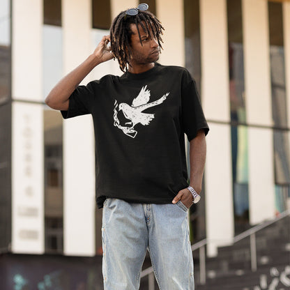 Young man models the Molotov Messenger T-shirt featuring a weathered white dove gripping a Molotov cocktail, symbolizing active resistance. Paired with baggy jeans, it embodies the spirit of defiance and action.