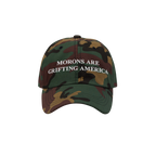 Camouflage dad hat featuring white "Morons Are Grifting America" text stitched on the front — a rebellious, anti-MAGA desig