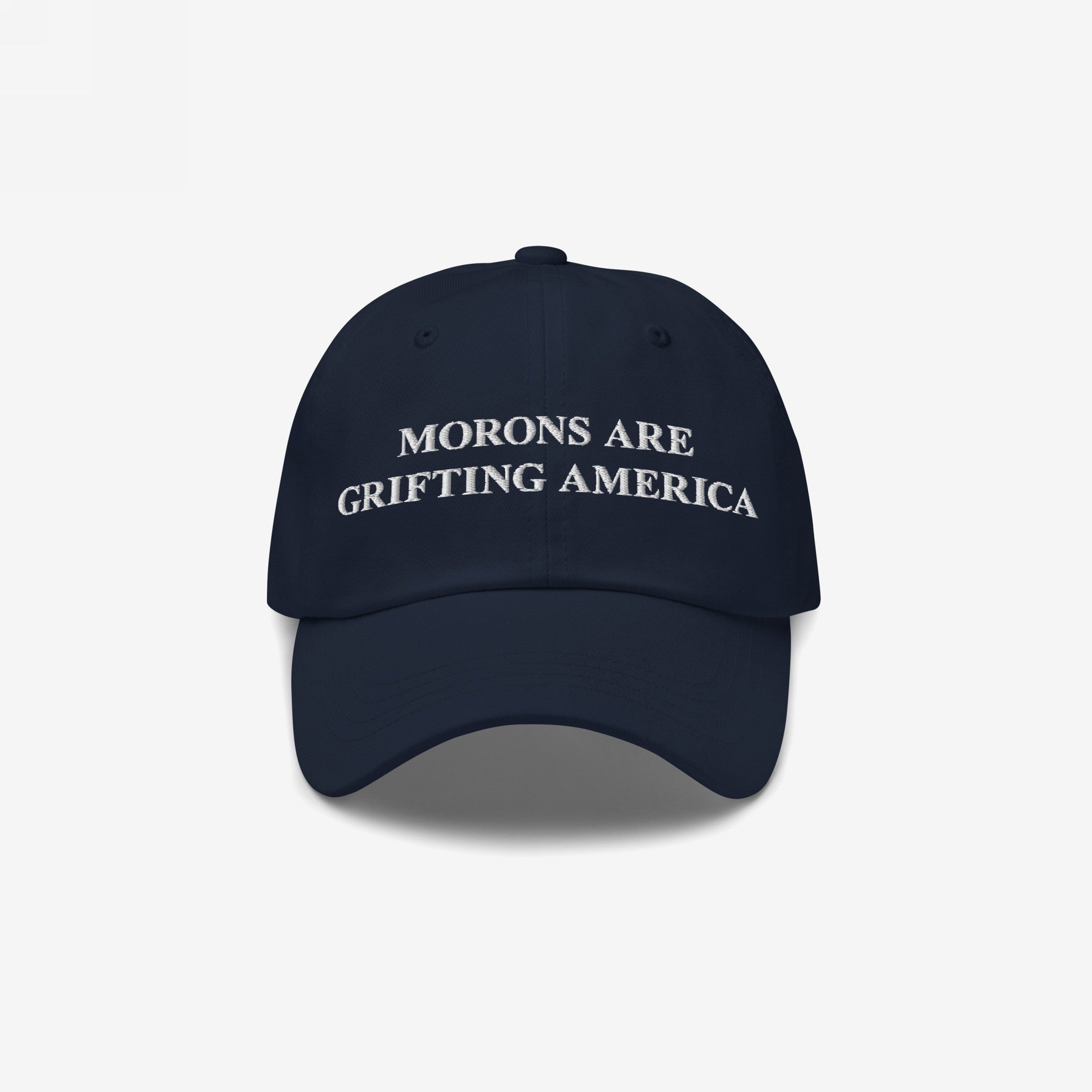 Navy blue dad hat with striking white embroidery of "Morons Are Grifting America" across the front — a sleek, understated take on the anti-MAGA callout.