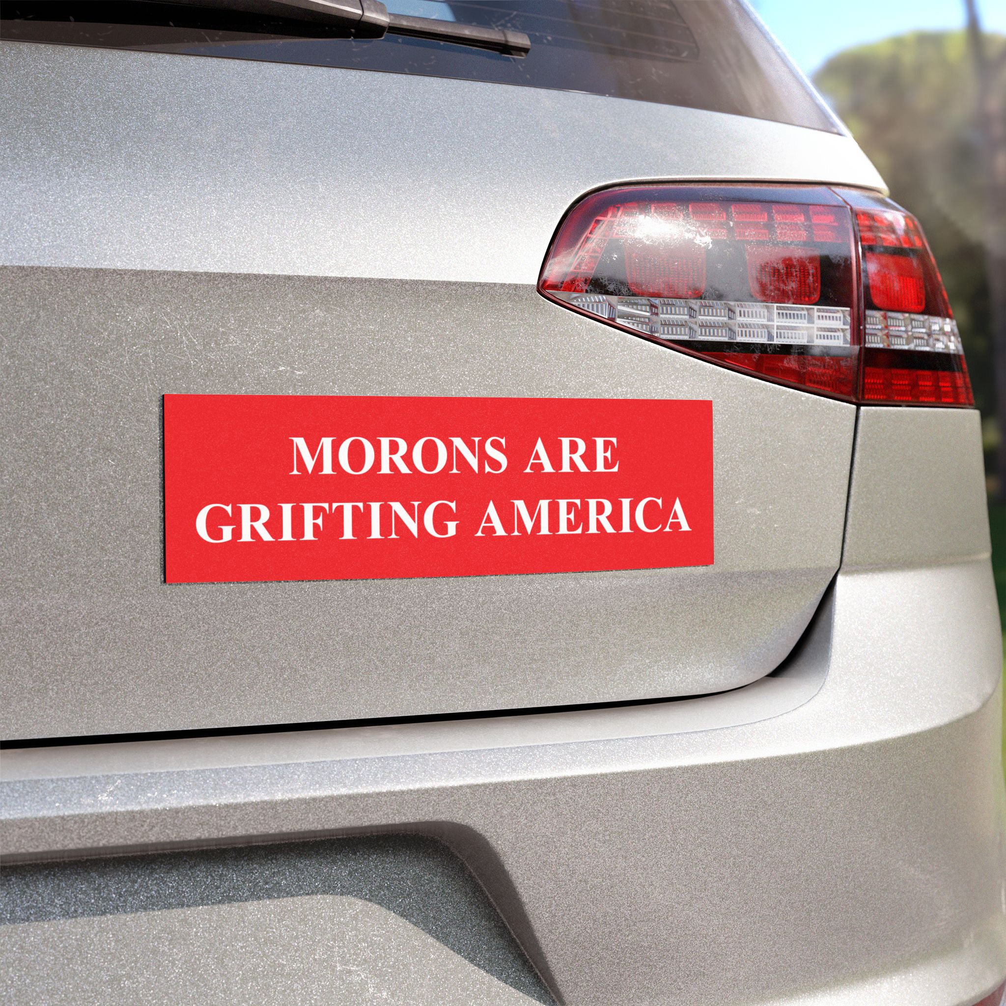Morons Are Grifting America bumper sticker displayed on a car trunk