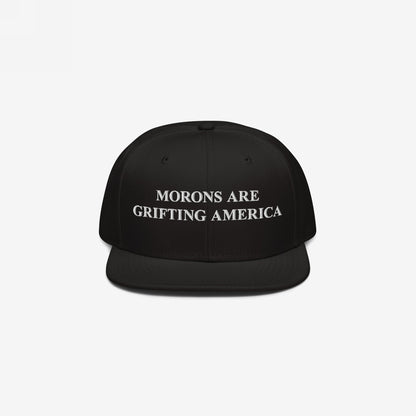 Black snapback cap with white embroidery reading “Morons Are Grifting America,” reflecting bold political realism. Ideal for those challenging the status quo. Ships from the EU, supporting Amnesty International.