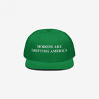 Kelly green snapback hat with white embroidery of the phrase "Morons Are Grifting America," designed as a sharp anti-MAGA political statement.