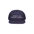 Navy blue snapback hat featuring white embroidered text "Morons Are Grifting America," delivering a clean and direct anti-MAG