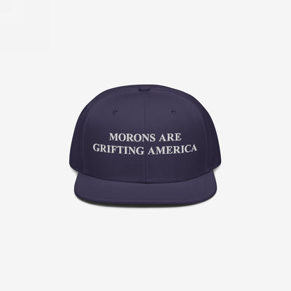 Navy blue snapback hat with Morons Are Grifting America embroidered in white block letters, reflecting a bold, unapologetic political statement. Ideal for those advocating truth and realism.