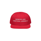 Red snapback hat with flat visor and bold white embroidery reading "Morons Are Grifting America," worn as an unapologetic ant