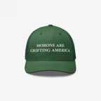 Retro green trucker hat featuring embroidered anti-MAGA message: "Morons Are Grifting America"