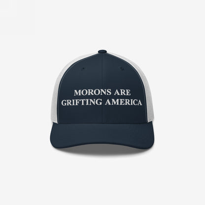 Navy-blue and white trucker-style baseball cap with Morons Are Grifting America embroidered in white. It embodies a bold, political statement for those challenging the status quo.