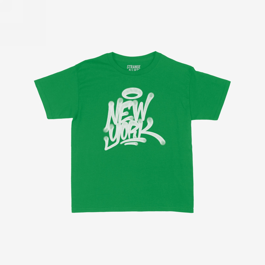 New York Handstyle Women's Baby Tee featuring a white graffiti-style New York with a halo graphic on a green short-sleeve shirt. Brand name STRANGE ALLIES visible inside the collar.