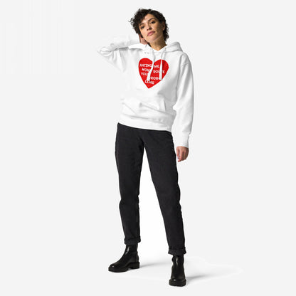 Model wearing the No Hate Hoodie & Sweatshirt featuring a distressed red heart with HATING ME WON’T SOLVE YOUR PROBLEMS, paired with slim-fit black jeans and black lug-sole ankle boots.