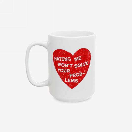 White ceramic No Hate Mug featuring a distressed red heart with bold, white text: Hating Me Won’t Solve Your Problems. Perfect for activists promoting self-worth. Available in two sizes, microwave, and dishwasher safe.