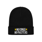 The No Kings No Masters Hat features a black rib-knit design with a fold-over cuff, showcasing the slogan “NO KINGS NO MAST