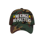 The No Kings No Masters Hat features a camouflage design with bold white embroidery and yellow crown accents, embodying rebel