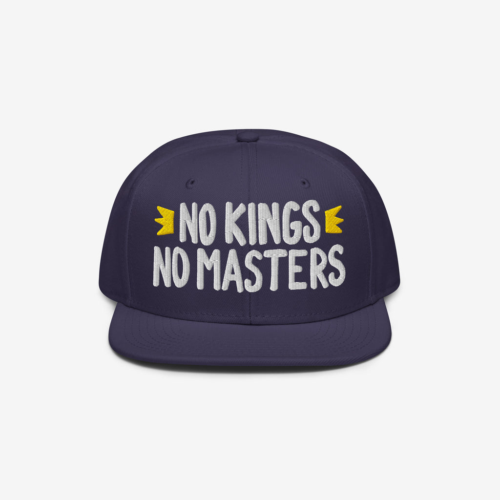 The No Kings No Masters Hat features bold white embroidery with yellow crowns, embodying a rebellious spirit against authority. Ideal for those challenging the system with style.