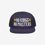 The No Kings No Masters Hat features bold white embroidery with yellow crowns, embodying a rebellious spirit against authority. Ideal for those challenging the system with style.
