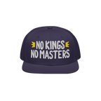 The No Kings No Masters Hat features bold white embroidery with yellow crowns, embodying a rebellious spirit against authorit