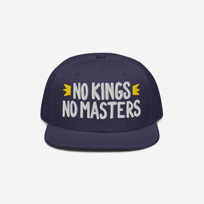 No Kings No Masters Hat featuring white embroidered slogan with yellow crown accents on a navy-blue flat-bill snapback, embodying rebellious style and defiance.
