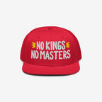 No Kings No Masters Hat with bold white slogan and yellow crown motifs, symbolizing defiance against authority. Ideal for stylish anarchists and rebels, supporting SPLC's mission for equality.