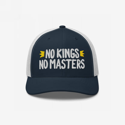 Trucker-style No Kings No Masters hat featuring navy front, white mesh back, and bold white embroidery. The cap embodies rebellion with hand-drawn accents, representing anti-authoritarian style and ethos.