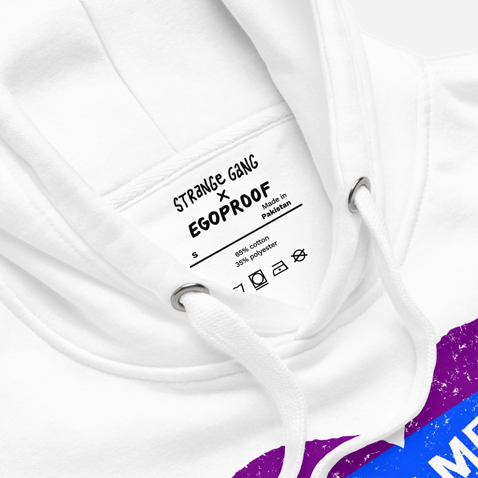 Close-up of No LGBTQ Hate Hoodie & Sweatshirt featuring a STRANGE GANG × EGOPROOF label, drawstring, and part of a colorful graphic with a rainbow heart design symbolizing LGBTQ pride and resistance.