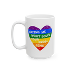 White ceramic No LGBTQ Hate Mug features a rainbow-striped heart with the phrase “HATING ME WON’T SOLVE YOUR PROBLEMS,”