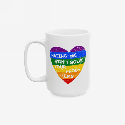 No LGBTQ Hate Mug featuring a distressed, rainbow-striped heart with the slogan Hating Me Won't Solve Your Problems, symbolizing LGBTQ+ allyship. Durable ceramic, available in 11 oz. and 15 oz. sizes.