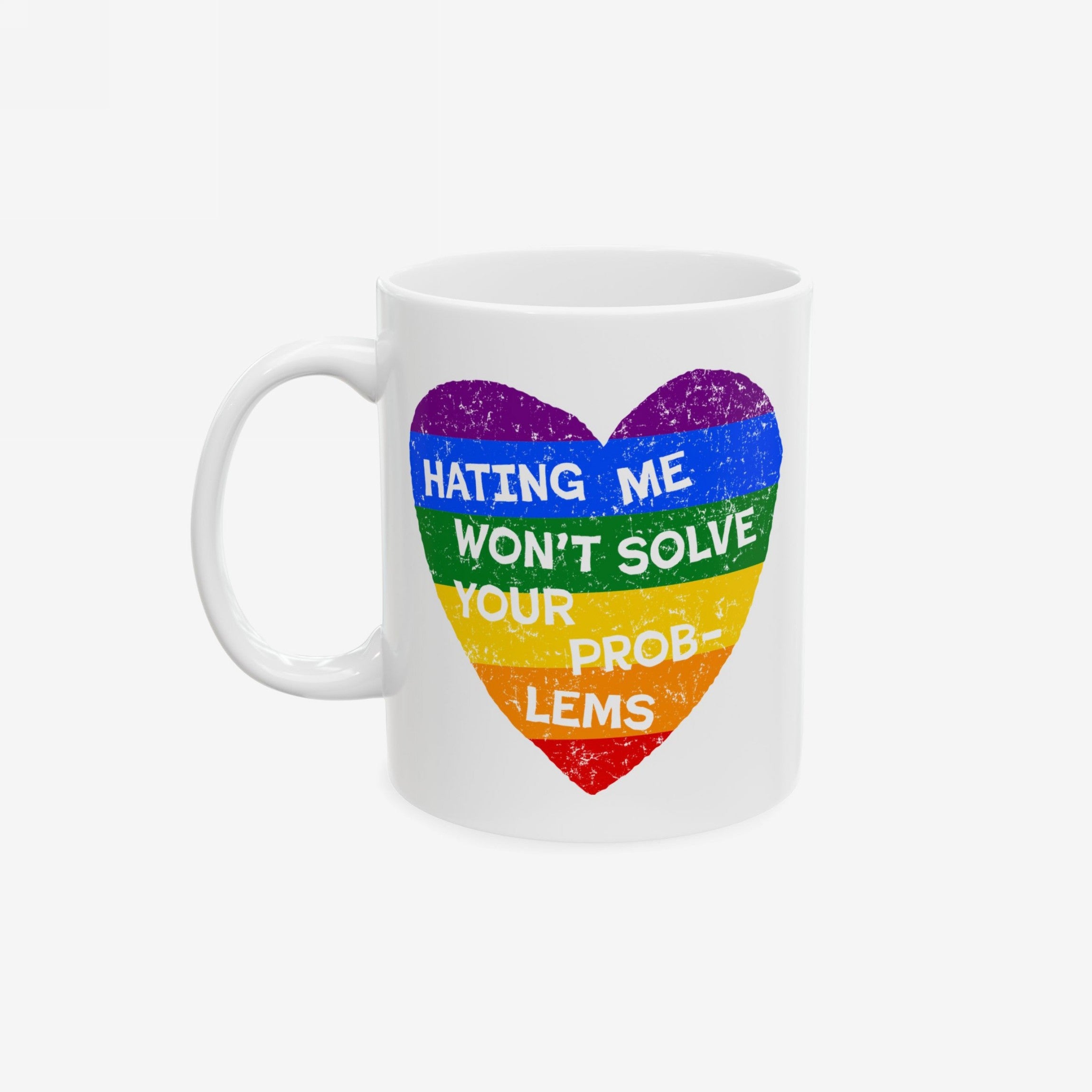 No LGBTQ Hate Mug featuring a rainbow-striped heart with the slogan HATING ME WON’T SOLVE YOUR PROBLEMS, embodying pride and equality. Ceramic, available in two sizes, microwave and dishwasher safe.
