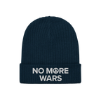No More Wars Hat: Dark-navy beanie with NO MORE WARS embroidered in white, featuring a peace-symbol icon in “MORE.” A bol