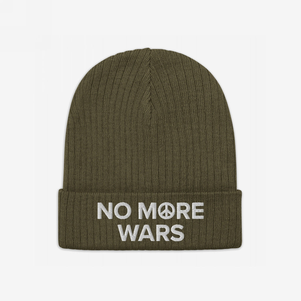 Olive-green ribbed knit beanie with NO MORE WARS embroidered in white across the cuff, featuring a peace symbol. A powerful statement piece promoting peace and resistance against war profiteering.