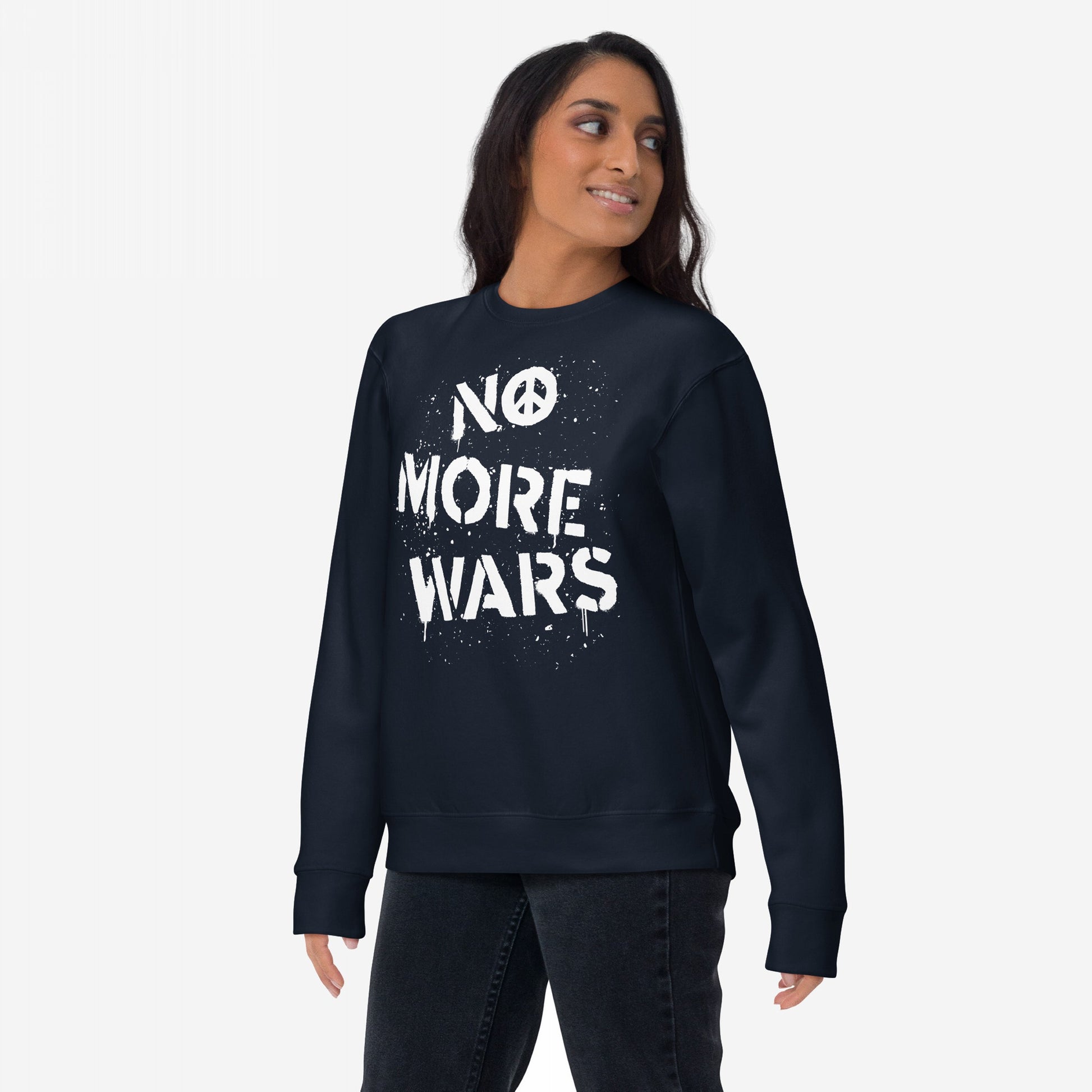 Woman wearing No More Wars Sweatshirt with bold, white stencil-style lettering and peace symbol. The design embodies a protest message against global violence, reflecting the store's advocacy for peace and equality.
