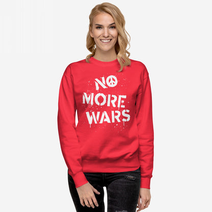 Model wearing the No More Wars Sweatshirt, featuring a white stencil-style slogan with a peace symbol, embodying a bold statement against global violence, paired with distressed jeans against a plain background.