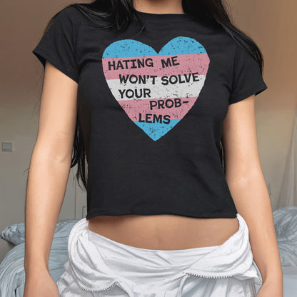 Person wearing the No Trans Hate Women's Baby Tee with a distressed trans pride heart and empowering slogan, showcasing solidarity and resistance against bigotry, paired with a light-colored garment around the hips.
