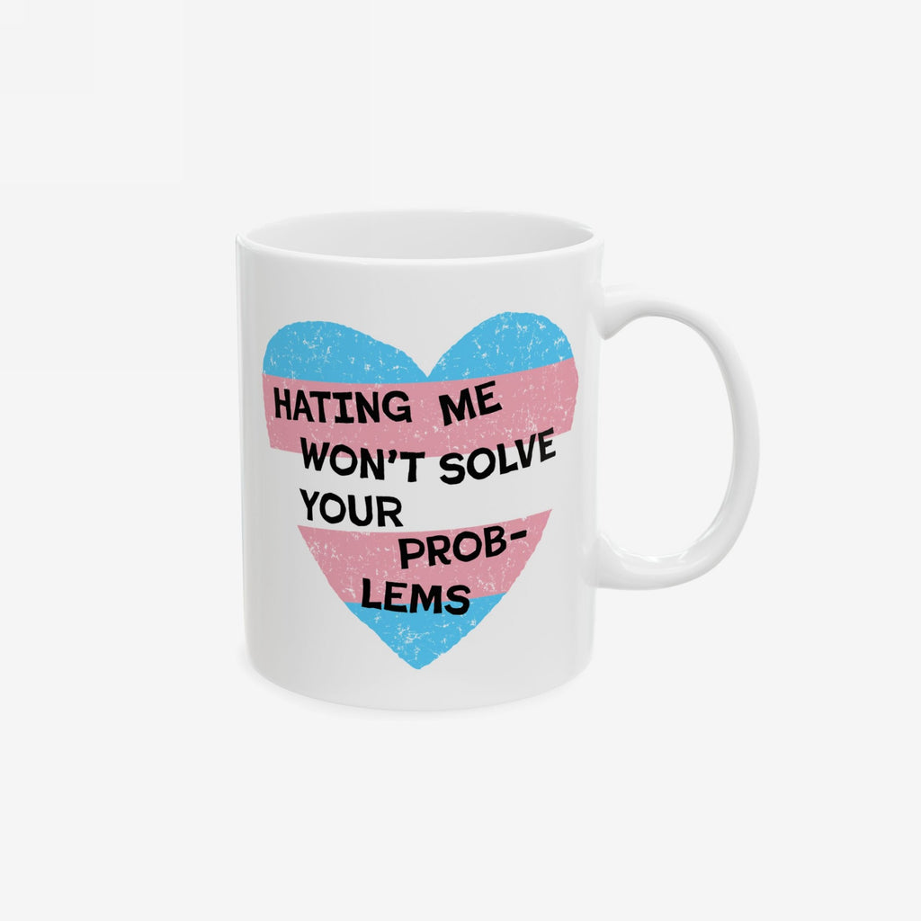 The No Trans Hate Mug features a heart in transgender pride colors with the message HATING ME WON'T SOLVE YOUR PROBLEMS, symbolizing trans visibility and strength.