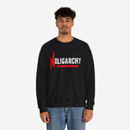 Male model wearing the No Oligarchy Shirt, featuring bold NOLIGARCHY print with a red graffiti-style N and underline, paired with blue jeans. This sweatshirt represents rebellion against elite influence.