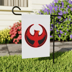 Northern Cardinal Rebel Alliance Garden Flag features a bold red phoenix emblem on a white flag, hanging from a black metal yard stake, set against greenery and colorful blooms, symbolizing protest and community values.