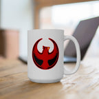 St. Louis Rebel Alliance Mug featuring a red-and-black phoenix emblem on a white ceramic body, symbolizing resistance and equality, sits on a wooden tabletop beside an open laptop.