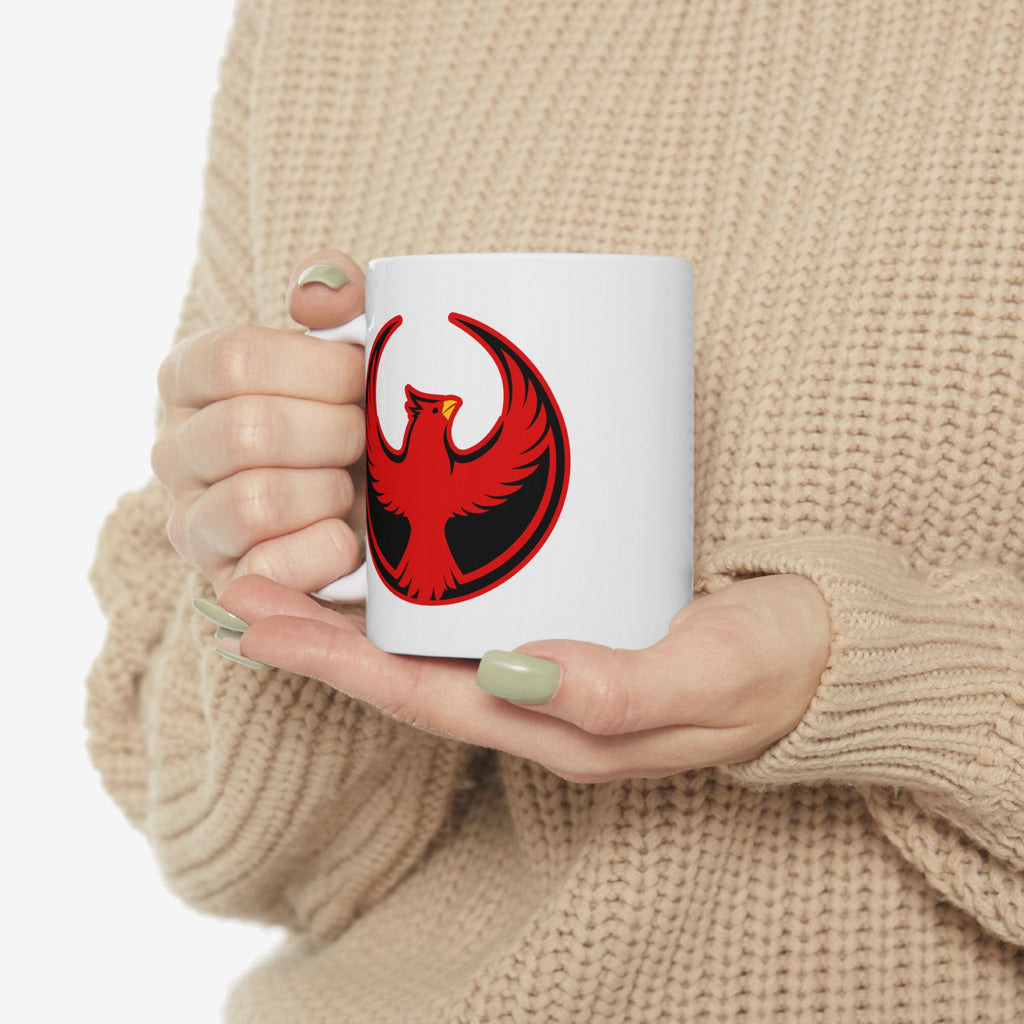 Person holding St. Louis Rebel Alliance Mug featuring a stylized red phoenix on a black crescent, embodying anti-fascist and pro-equality themes. The mug is ceramic, dishwasher, and microwave safe.