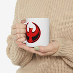 Person holding St. Louis Rebel Alliance Mug featuring a stylized red phoenix on a black crescent, embodying anti-fascist and pro-equality themes. The mug is ceramic, dishwasher, and microwave safe.