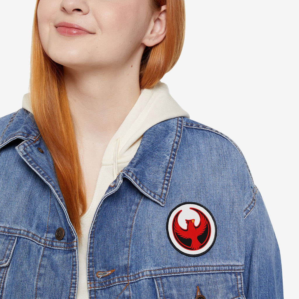 Close-up of a person wearing a blue denim jacket displaying the Northern Cardinal Rebel Alliance Patch, a bold 3 x 3 emblem of a red cardinal, symbolizing protest and solidarity.