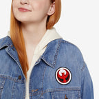 Close-up of a person wearing a blue denim jacket displaying the Northern Cardinal Rebel Alliance Patch, a bold 3 x 3 emblem of a red cardinal, symbolizing protest and solidarity.