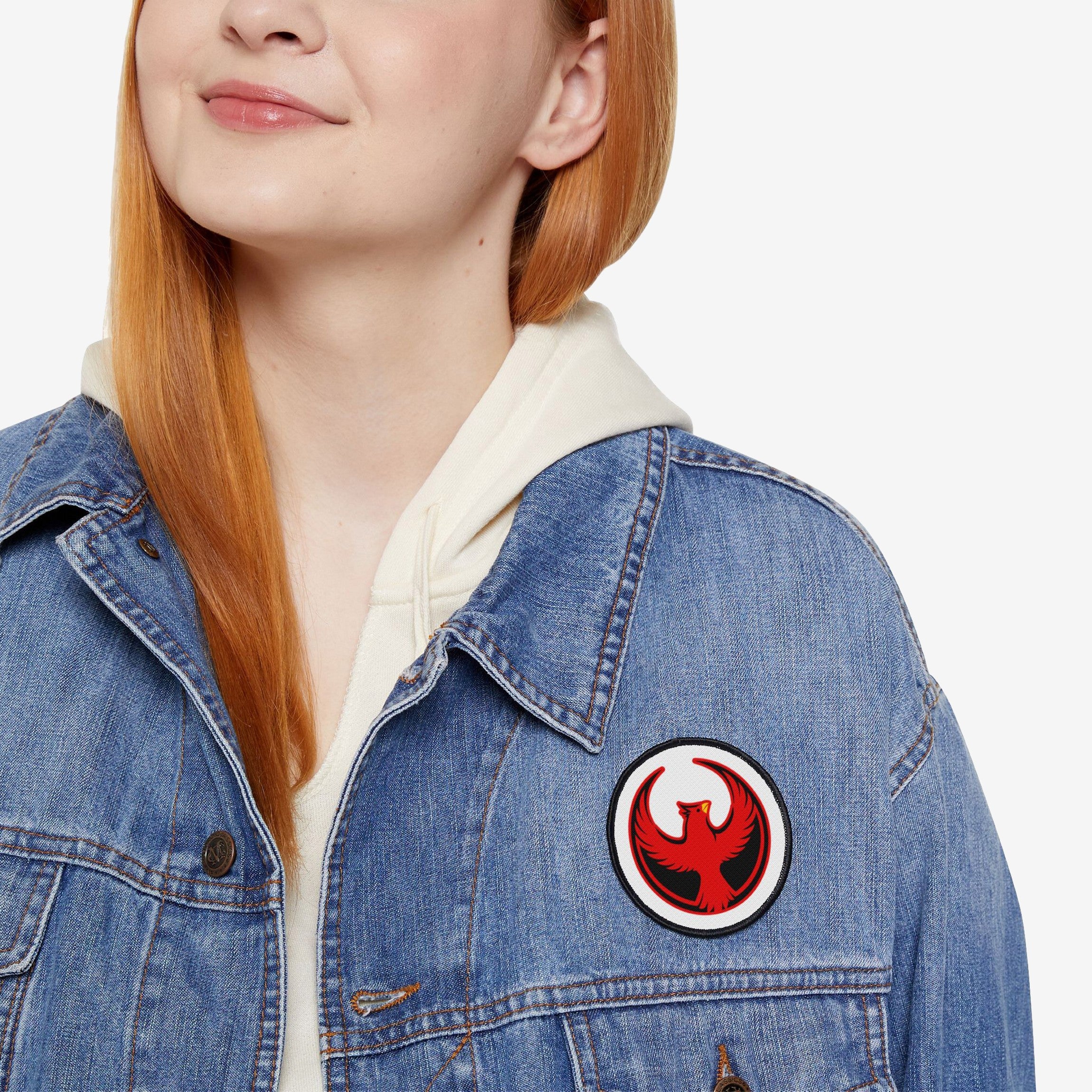 Close-up of a person wearing a blue denim jacket displaying the Northern Cardinal Rebel Alliance Patch, a bold 3 x 3 emblem of a red cardinal, symbolizing protest and solidarity.