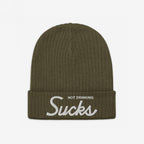 The Not Drinking Sucks Hat is an olive-green rib-knit beanie with a folded cuff, featuring white embroidered text that captures a playful, bold attitude perfect for any casual outing.