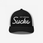 The Not Drinking Sucks Hat features a black front with bold “Not Drinking Sucks” embroidery. This playful trucker cap embodies a cheeky party vibe with its white mesh back and structured design.