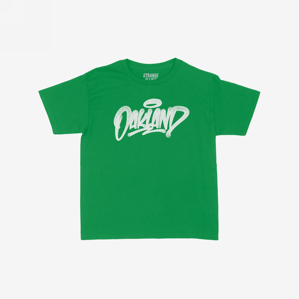 Oakland Handstyle Women's Baby Tee featuring a stylized white Oakland graffiti logo with a halo tag on a green short-sleeved shirt, embodying a confident, urban style ideal for city enthusiasts.