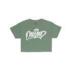 Oakland Handstyle Women's Baby Tee featuring a stylized white Oakland graffiti logo with a halo tag on a green short-sleeved 