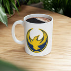 Oregon Rebel Alliance Mug featuring a golden-yellow bird emblem on a white ceramic surface, filled with black coffee, symbolizing anti-fascist and community spirit, perfect for activists and supporters alike.