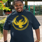 Man wearing an Oregon Rebel Alliance T-shirt featuring a yellow stylized bird emblem, standing outdoors with greenery and a fence in the background, reflecting values of resistance and support for equality.